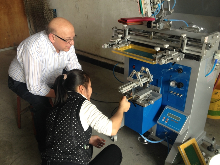 Israel customer training on the embossing machine curve screen printer pad printers and digital foiling machine